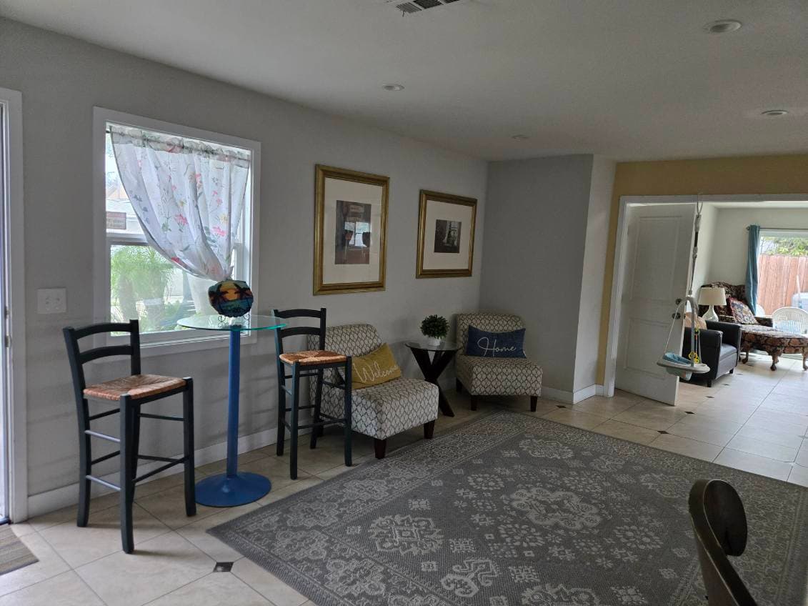 Agape House 3 living area — cozy seating with natural light and artwork